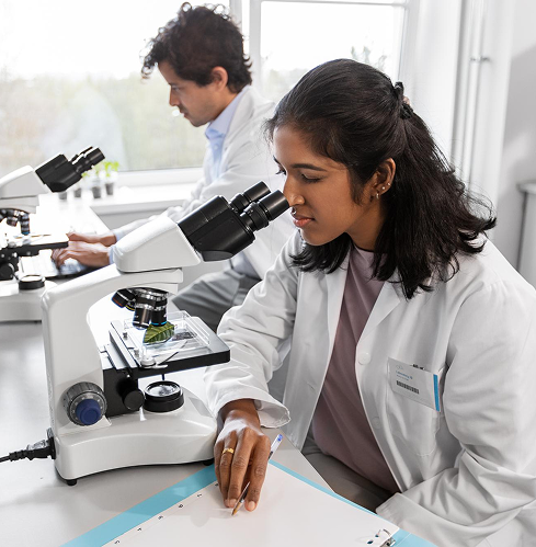 scientists-with-microscopes-working-laboratory
